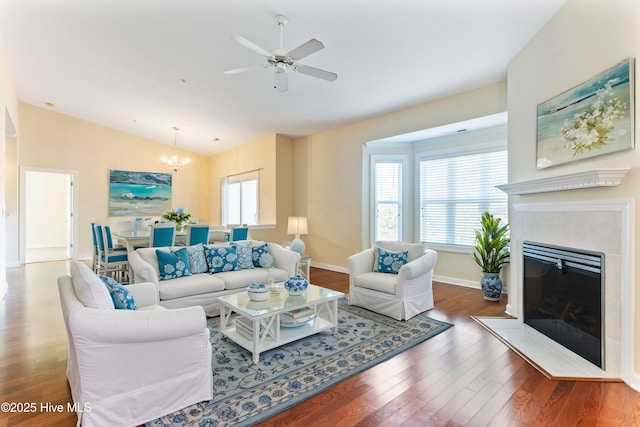 living room featuring hardwood / wood-style flooring, lofted ceiling, a healthy amount of sunlight, and a fireplace