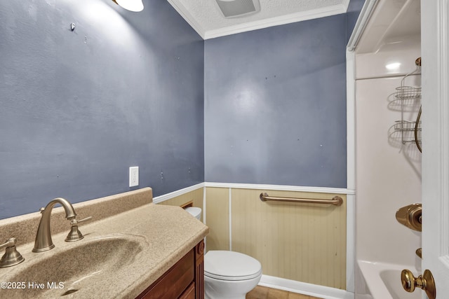 bathroom with crown molding, vanity, a textured ceiling, a tub, and toilet