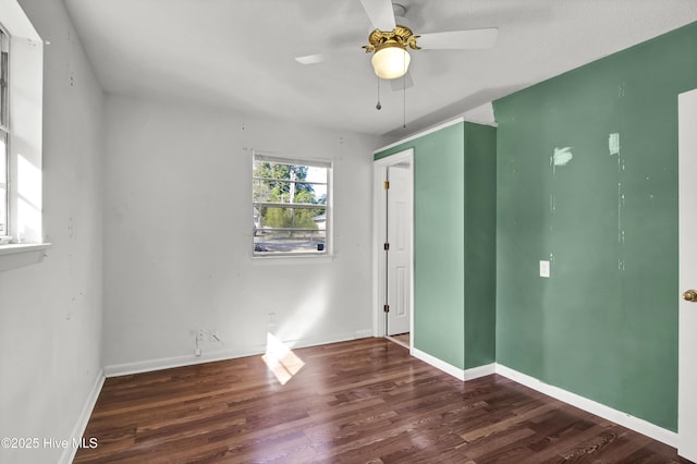 unfurnished bedroom with dark hardwood / wood-style flooring and ceiling fan