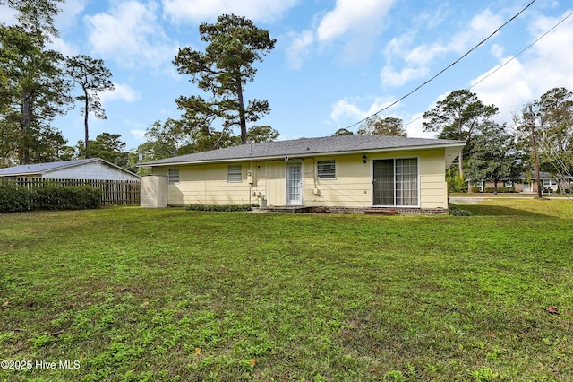 back of property featuring a yard