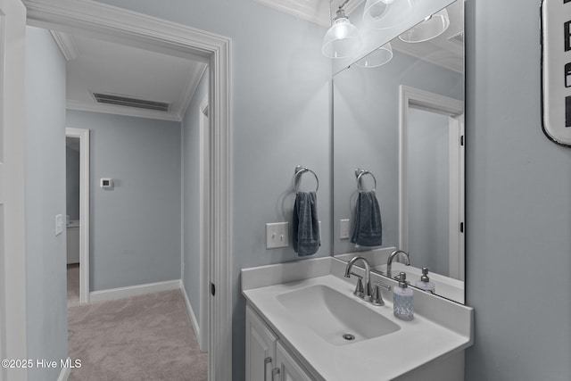 bathroom with vanity and ornamental molding