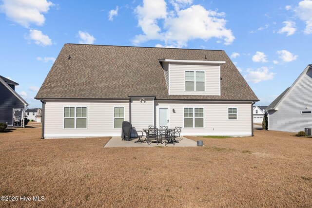 rear view of house featuring a patio area and a lawn