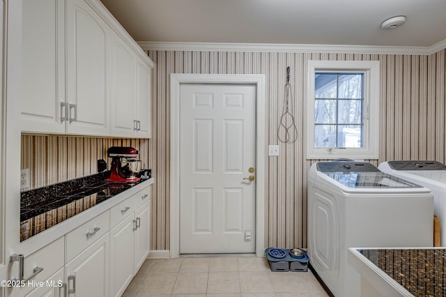 washroom with crown molding, cabinets, light tile patterned floors, and independent washer and dryer