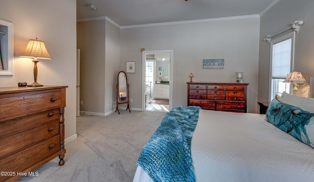 carpeted bedroom with crown molding and ensuite bath