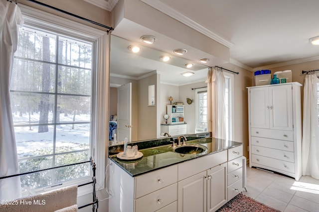 bathroom with tile patterned flooring, crown molding, and vanity