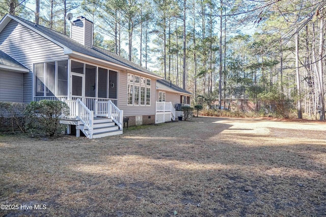 view of side of property with a sunroom