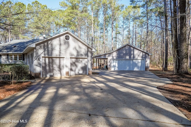 view of side of home with a garage and an outdoor structure