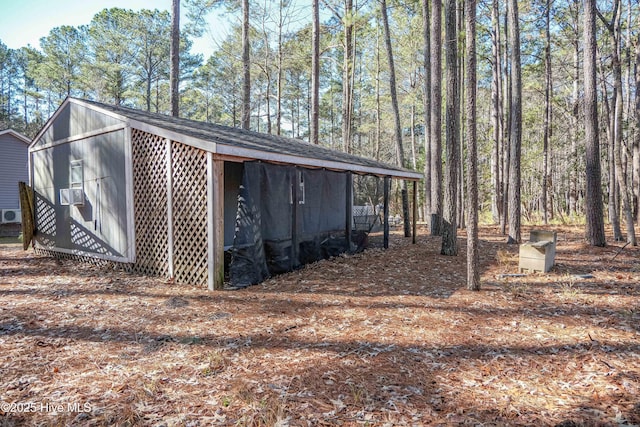 view of home's exterior with cooling unit and an outdoor structure