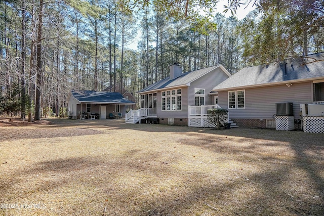 rear view of house with a yard