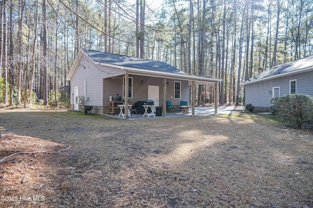 view of side of property featuring a patio area