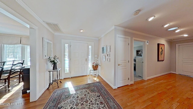 foyer featuring crown molding and light wood-type flooring