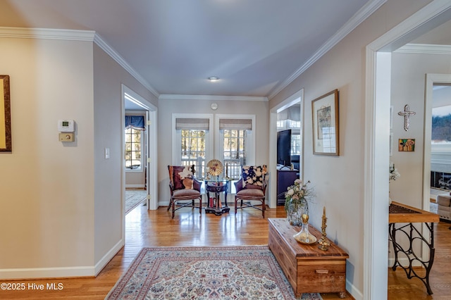 corridor featuring crown molding and light hardwood / wood-style floors