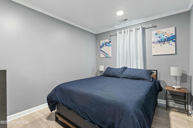 bedroom featuring crown molding and light wood-type flooring