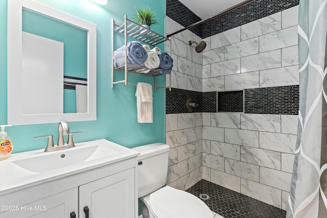 bathroom with walk in shower, vanity, and toilet