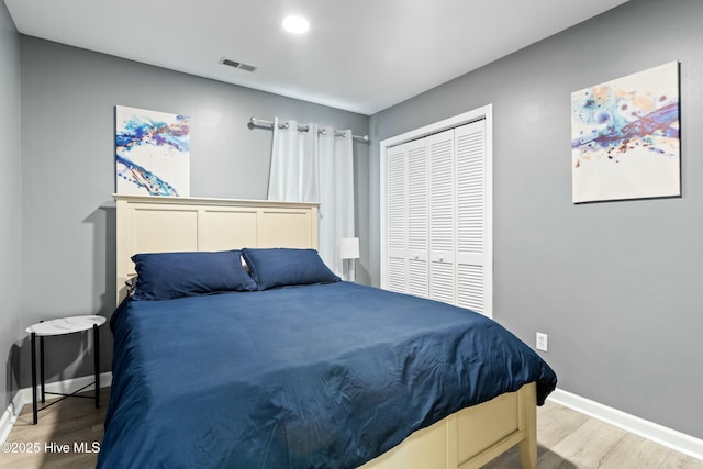 bedroom featuring a closet and light wood-type flooring