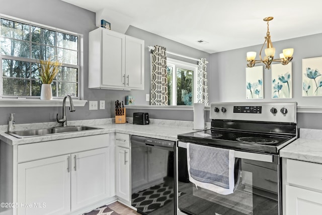 kitchen with sink, stainless steel range with electric cooktop, white cabinetry, light stone counters, and dishwasher