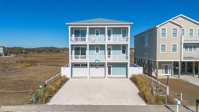 view of front of property featuring a balcony and a garage