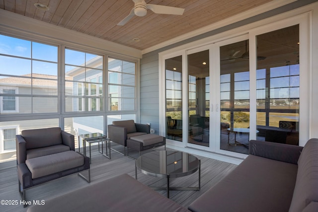 sunroom / solarium with wood ceiling and ceiling fan