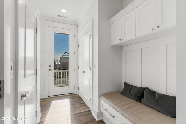 mudroom with ornamental molding and light wood-type flooring