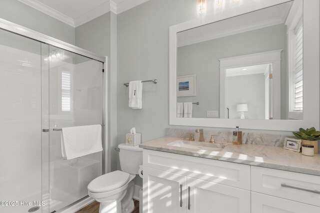 1012 Ocean Blvd W, Holden Beach, NC 28462 - full bathroom featuring a stall shower, ornamental molding, vanity, and toilet