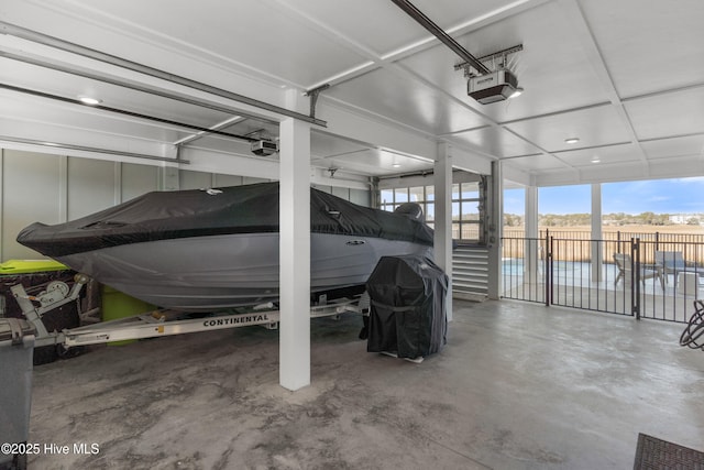 1012 Ocean Blvd W, Holden Beach, NC 28462 - garage featuring a fenced in pool and a garage door opener