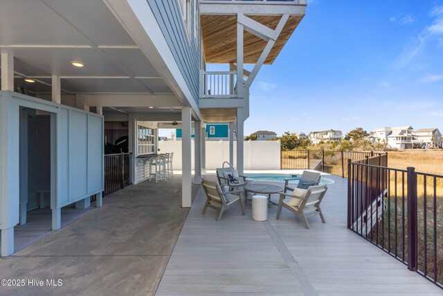1012 Ocean Blvd W, Holden Beach, NC 28462 - view of patio / terrace featuring a residential view, a fenced in pool, a fenced backyard, and outdoor dry bar