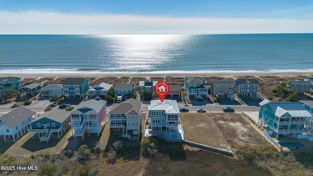 drone / aerial view featuring a beach view and a water view