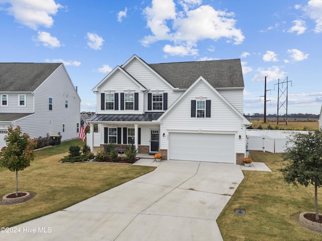 view of front facade featuring a front yard, a porch, and a garage