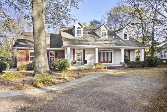 new england style home with covered porch