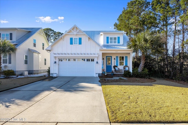 view of front of property featuring metal roof, a porch, an attached garage, driveway, and board and batten siding