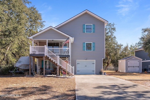 front of property featuring a garage, covered porch, and a shed