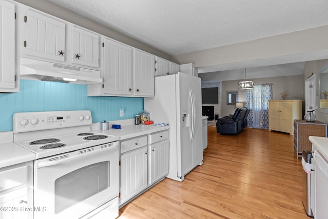 kitchen with a textured ceiling, white cabinets, and white appliances