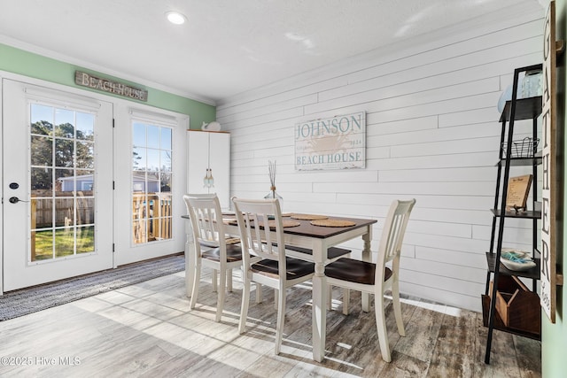 dining room with hardwood / wood-style flooring and crown molding