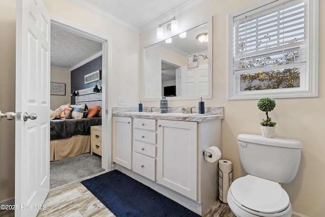 bathroom featuring ornamental molding, hardwood / wood-style floors, vanity, and toilet