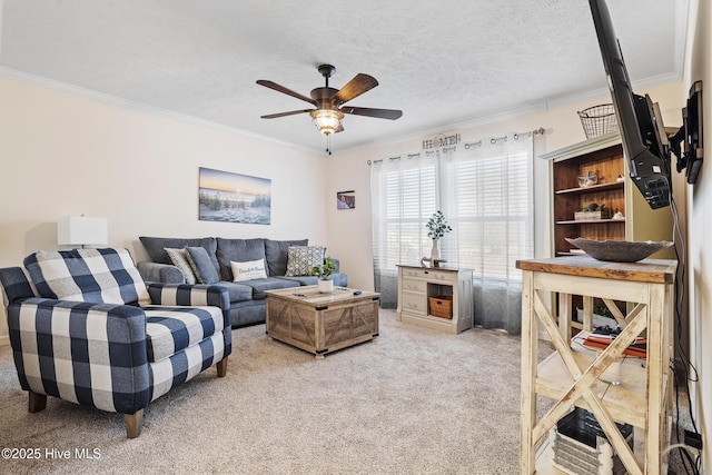 carpeted living room featuring crown molding, ceiling fan, and a textured ceiling