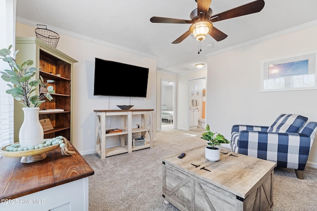 living room with ornamental molding, light colored carpet, and ceiling fan