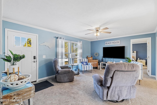 living room featuring ceiling fan, ornamental molding, and carpet