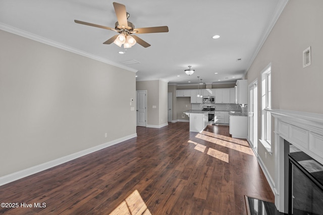 unfurnished living room with ceiling fan, ornamental molding, dark hardwood / wood-style floors, and a fireplace