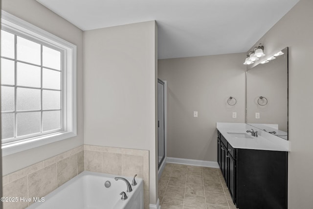 bathroom featuring tile patterned floors, vanity, and shower with separate bathtub