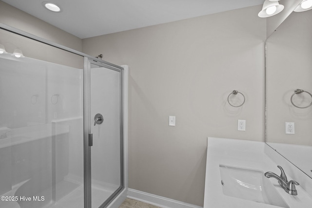 bathroom featuring walk in shower and vanity