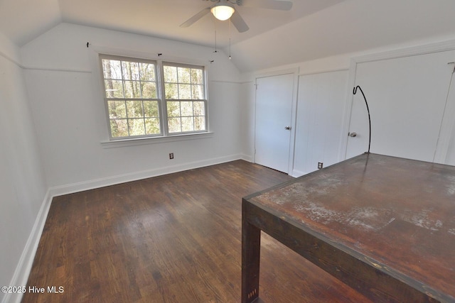 unfurnished bedroom with vaulted ceiling, ceiling fan, and dark wood-type flooring