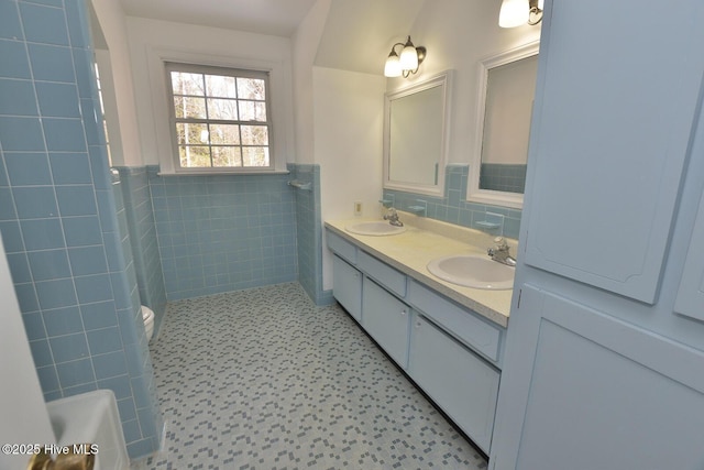 bathroom featuring tile walls, toilet, and vanity