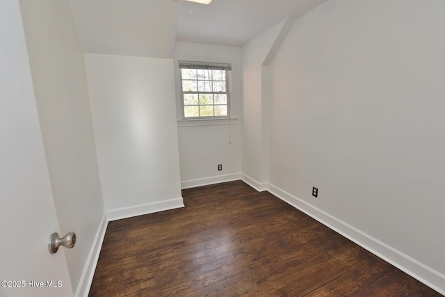 spare room featuring dark wood-type flooring