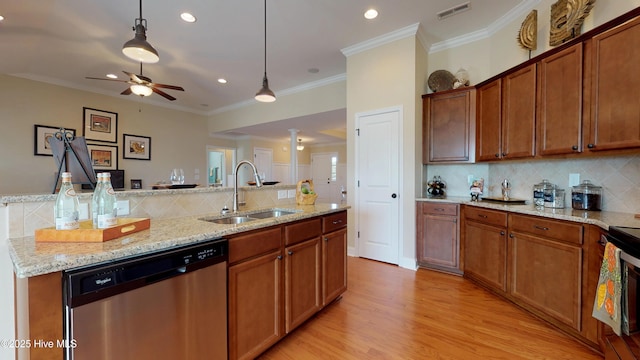 kitchen featuring dishwasher, decorative light fixtures, decorative backsplash, sink, and light stone counters