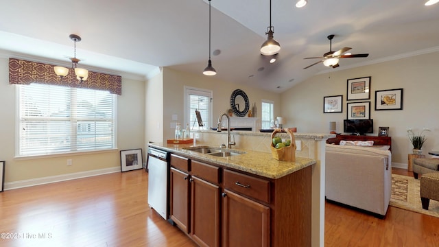 kitchen featuring hanging light fixtures, stainless steel dishwasher, sink, an island with sink, and lofted ceiling