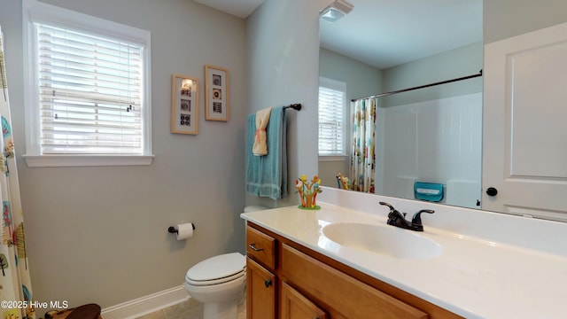 bathroom featuring tile patterned flooring, toilet, vanity, and walk in shower