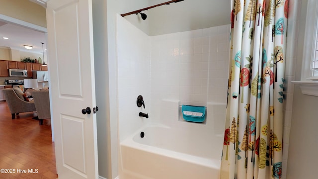 bathroom with wood-type flooring and shower / bath combination with curtain