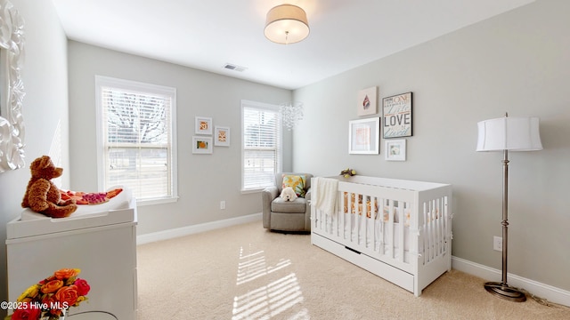 bedroom with light carpet and a crib