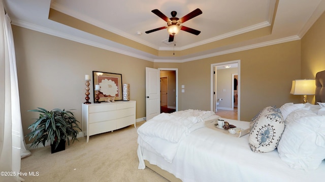 carpeted bedroom featuring ceiling fan, ornamental molding, and a raised ceiling