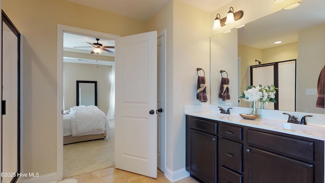 bathroom with an enclosed shower, tile patterned floors, ceiling fan, and vanity